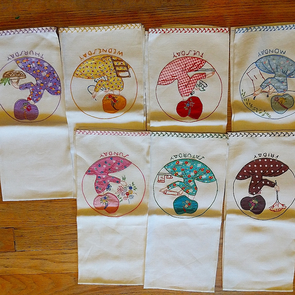 Seven vintage hand embroidered tea towels